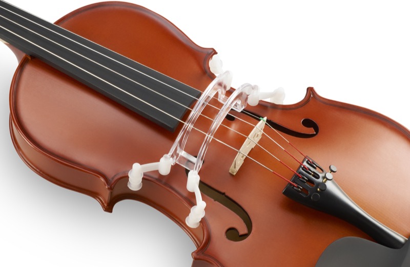 A clear plastic curved frame attached to the front of violin with white plastic grippers. The plastic curves over the top of the strings.